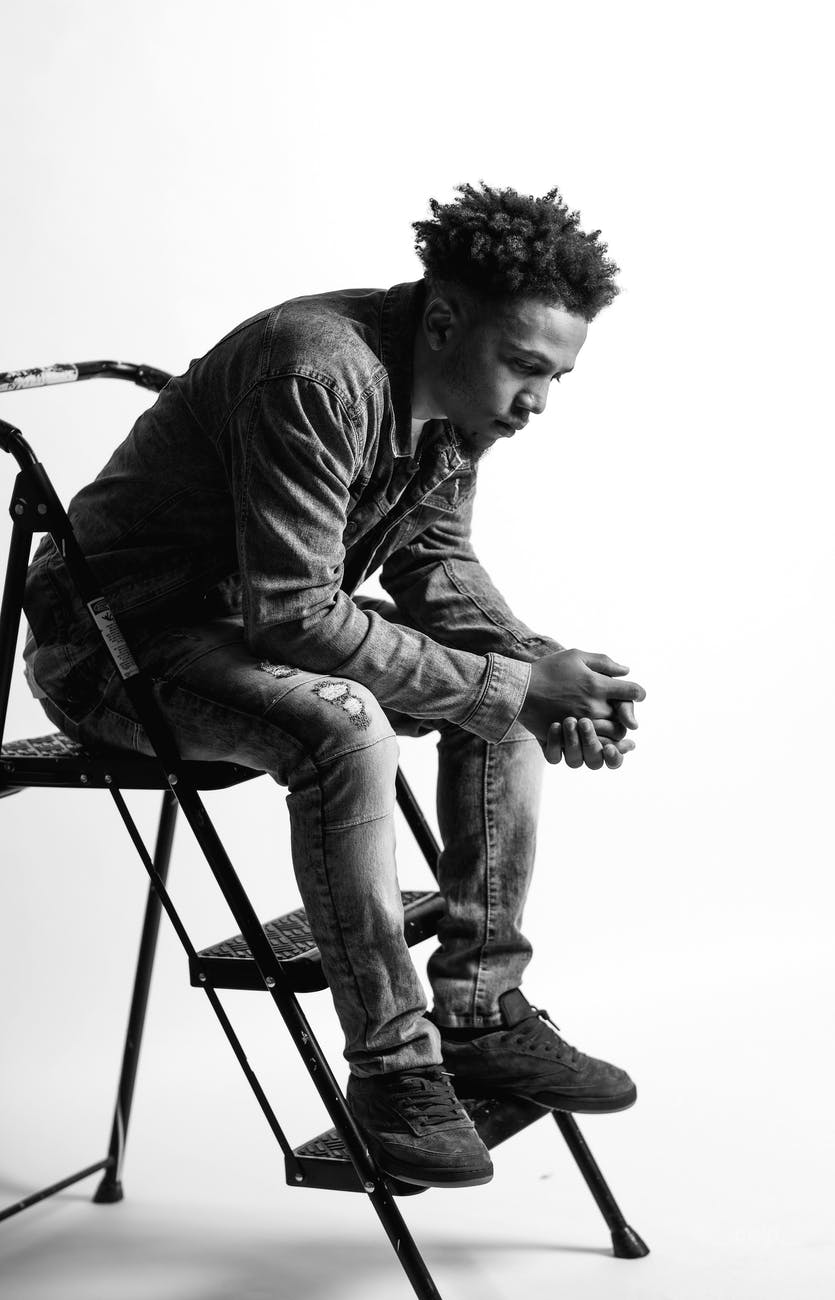 man sitting on step ladder